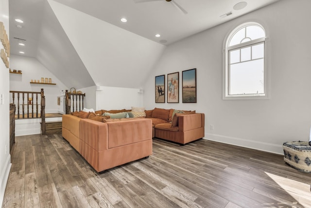 living area featuring vaulted ceiling, wood finished floors, visible vents, and baseboards