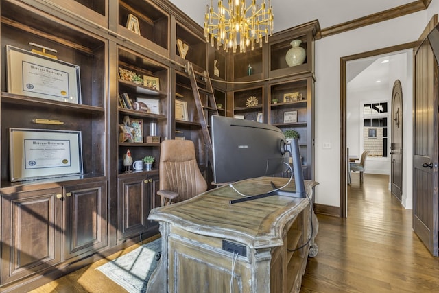 home office featuring a notable chandelier, baseboards, and wood finished floors