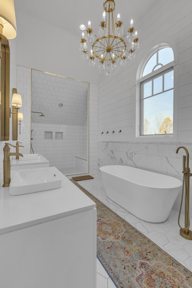 bathroom featuring a soaking tub, a sink, tile walls, and double vanity