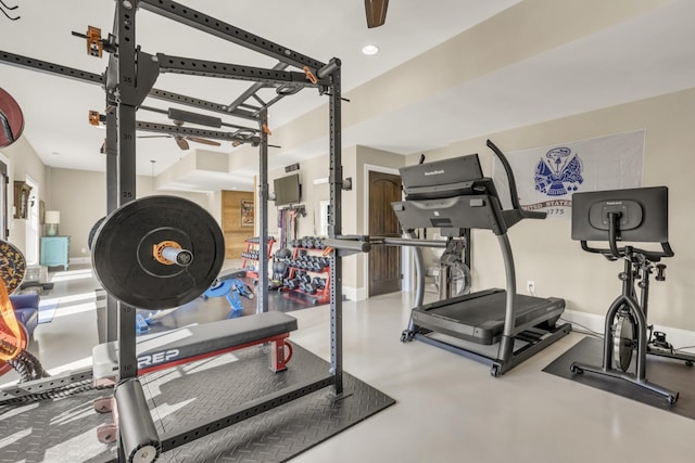 workout room featuring baseboards