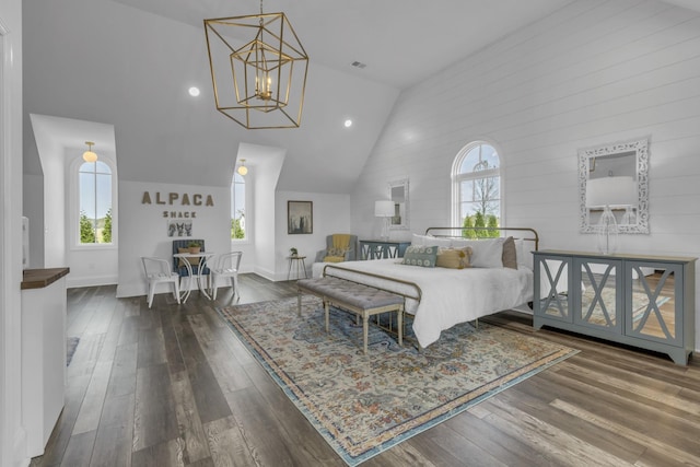 bedroom with high vaulted ceiling, a notable chandelier, visible vents, baseboards, and dark wood-style floors