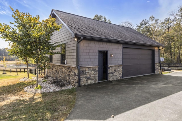 detached garage featuring fence