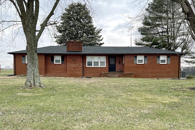 ranch-style house with a front yard, a chimney, central AC, and brick siding