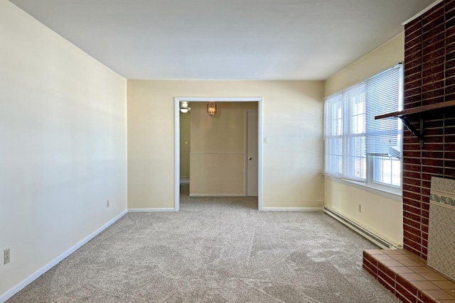 empty room featuring a baseboard heating unit, a large fireplace, carpet flooring, and baseboards