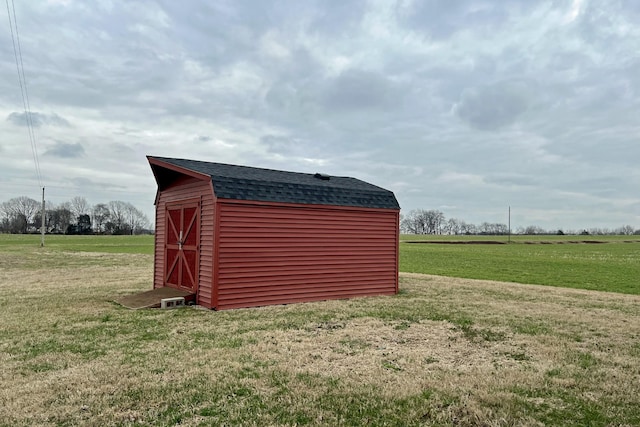 view of shed with a rural view