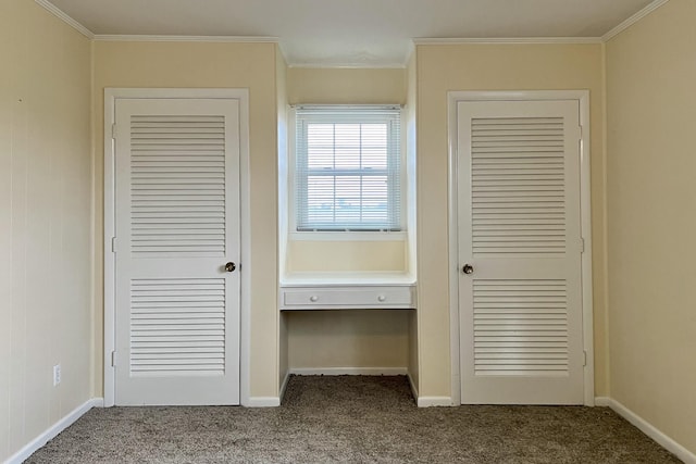 interior space with baseboards, ornamental molding, and carpet flooring