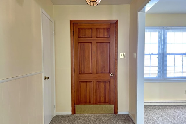 doorway featuring carpet and baseboard heating