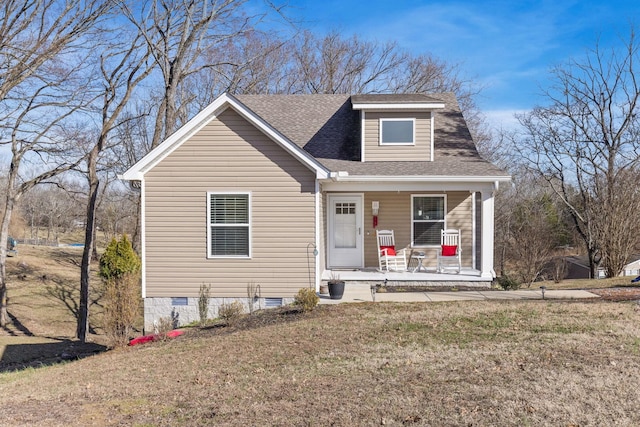 bungalow-style house with covered porch, roof with shingles, a front lawn, and crawl space