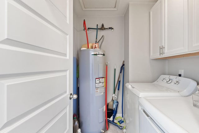 laundry room with water heater, cabinet space, and separate washer and dryer