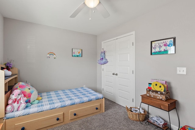 carpeted bedroom featuring ceiling fan and a closet