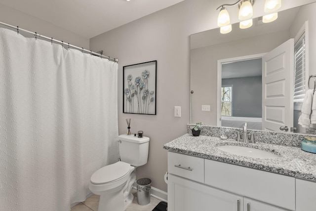 bathroom featuring toilet, tile patterned flooring, baseboards, and vanity