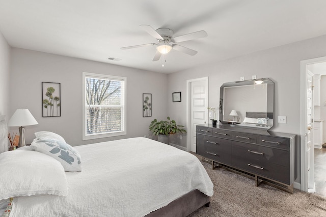 bedroom with ceiling fan, carpet, ensuite bath, and visible vents