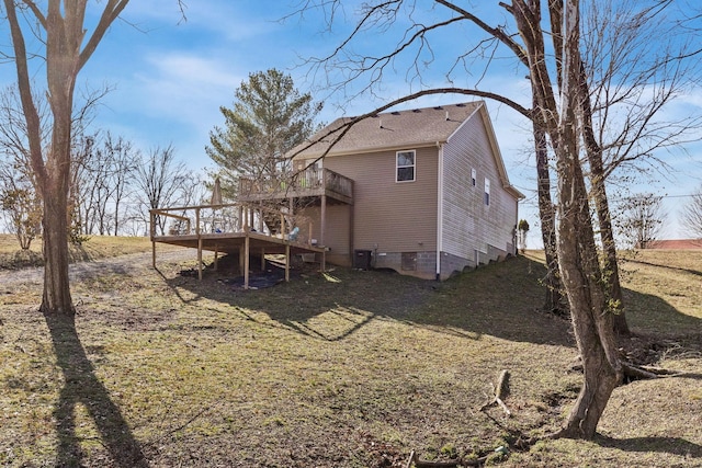 rear view of house featuring crawl space, central AC, a lawn, and a wooden deck