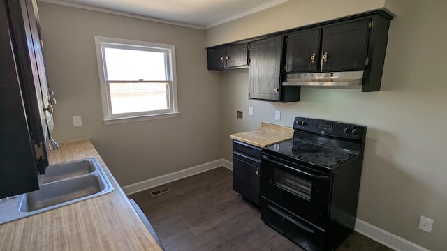 kitchen with black electric range, light countertops, under cabinet range hood, and dark cabinetry