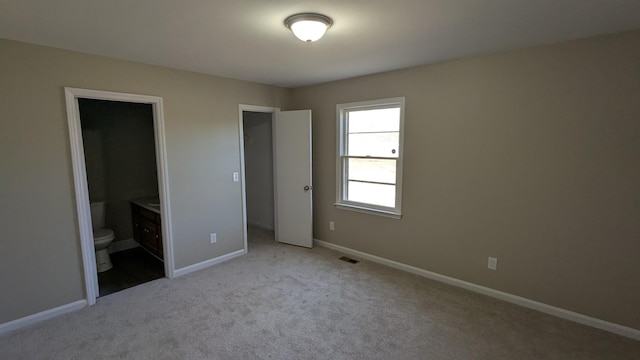 unfurnished bedroom with light carpet, visible vents, and baseboards