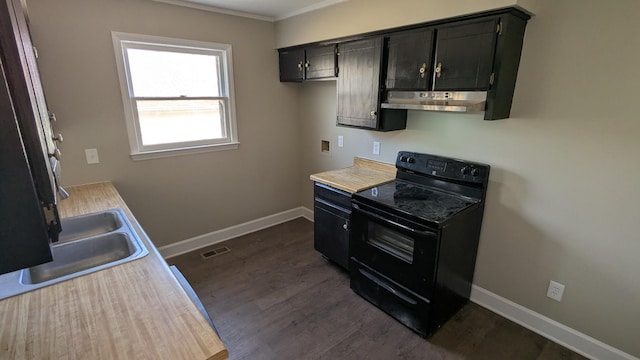 kitchen featuring black range with electric stovetop, dark cabinets, visible vents, and under cabinet range hood