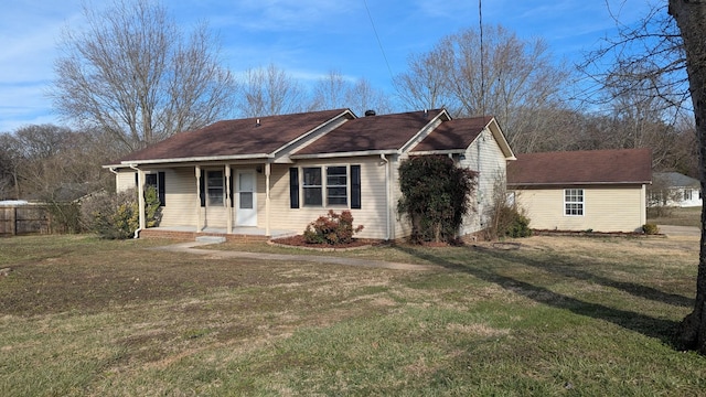 ranch-style house featuring covered porch and a front lawn