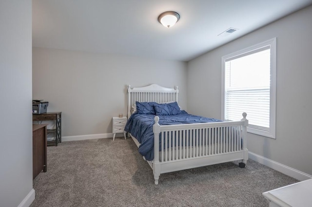 carpeted bedroom with visible vents and baseboards