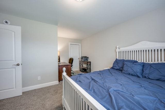 bedroom with carpet floors and baseboards