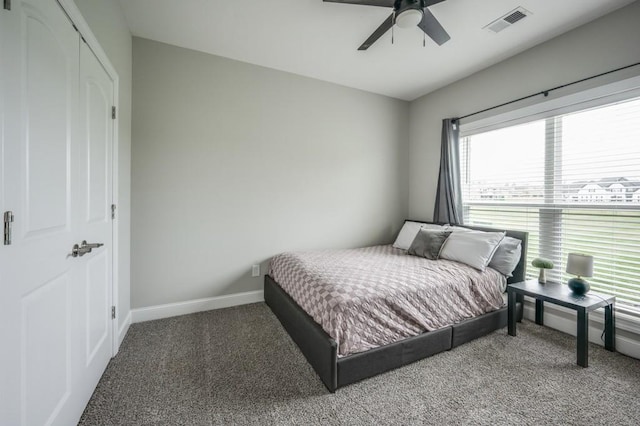 carpeted bedroom featuring visible vents, ceiling fan, and baseboards