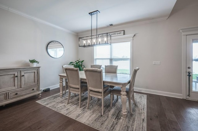 dining room featuring dark wood-style flooring, plenty of natural light, and crown molding