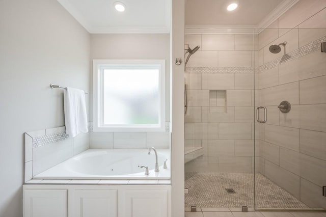 full bathroom featuring ornamental molding, a stall shower, and a garden tub