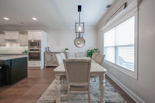 dining room with recessed lighting, dark wood-style flooring, visible vents, baseboards, and crown molding