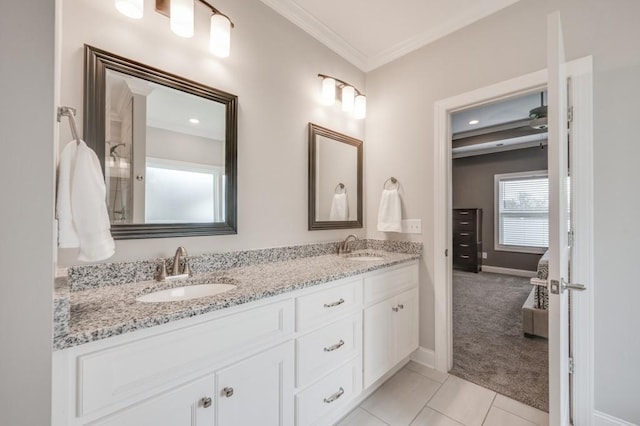 full bath with crown molding, tile patterned floors, a sink, and double vanity