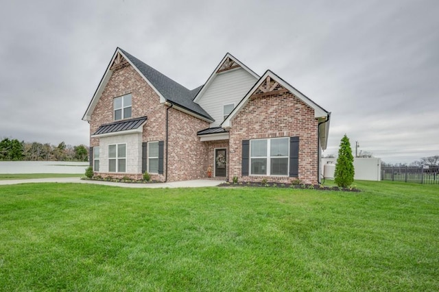 craftsman-style house with a front yard, a standing seam roof, brick siding, and metal roof