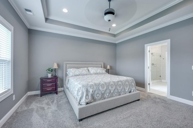 bedroom featuring light carpet, multiple windows, visible vents, and a tray ceiling