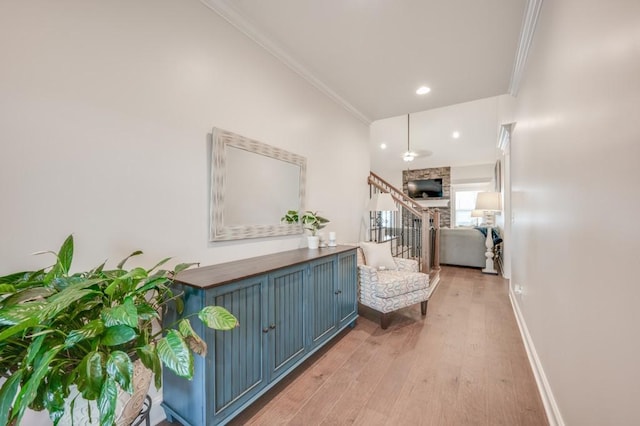 interior space with light wood finished floors, baseboards, ornamental molding, stairs, and recessed lighting