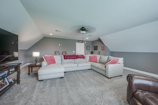 living room with baseboards, vaulted ceiling, and light colored carpet