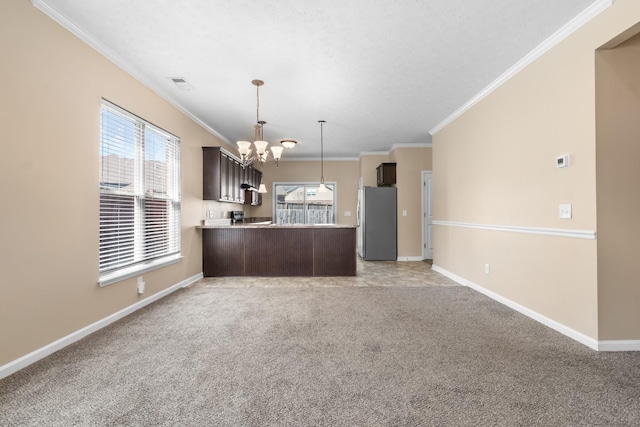 kitchen with a chandelier, visible vents, light countertops, dark brown cabinets, and freestanding refrigerator