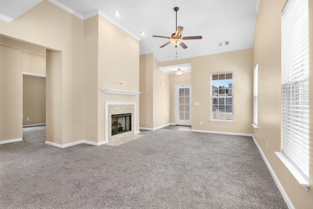 unfurnished living room with carpet floors, visible vents, high vaulted ceiling, and a tiled fireplace