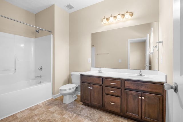 bathroom featuring toilet, double vanity, visible vents, and a sink