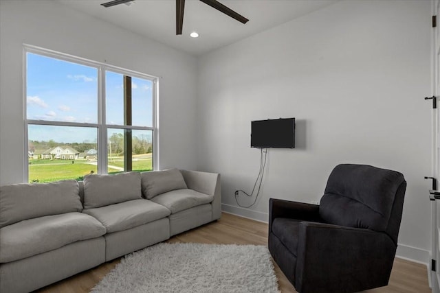 living area with light wood-style flooring and baseboards