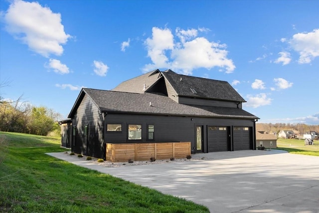 exterior space with a yard, an attached garage, and driveway