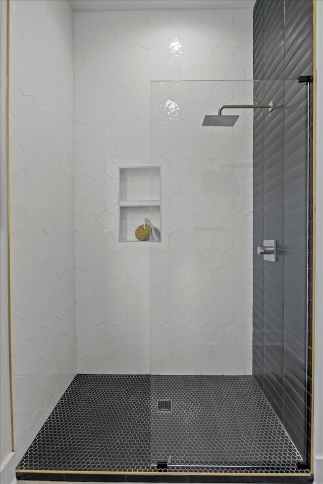 full bath with a tile shower