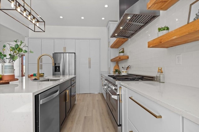 kitchen featuring white cabinets, range hood, appliances with stainless steel finishes, and open shelves