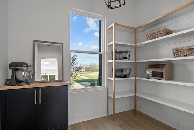 doorway to outside featuring light wood-style flooring and baseboards