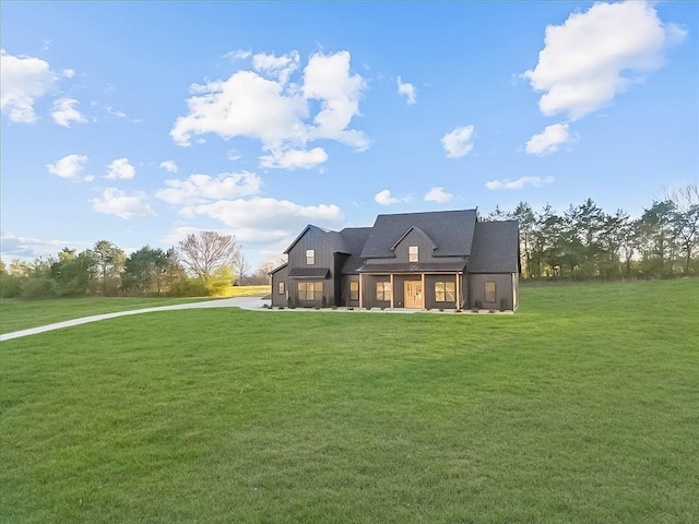 rear view of property featuring a yard