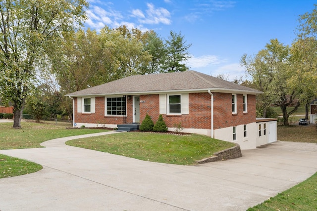 ranch-style home with concrete driveway, roof with shingles, fence, a front lawn, and brick siding