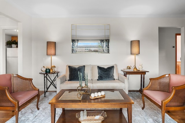 living room with ornamental molding, wood finished floors, and baseboards