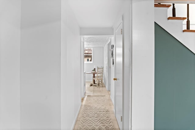 hall featuring light tile patterned floors