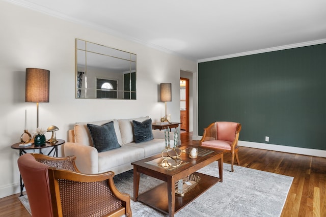 living area featuring ornamental molding, wood finished floors, and baseboards