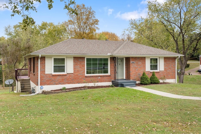 single story home with a shingled roof and a front yard