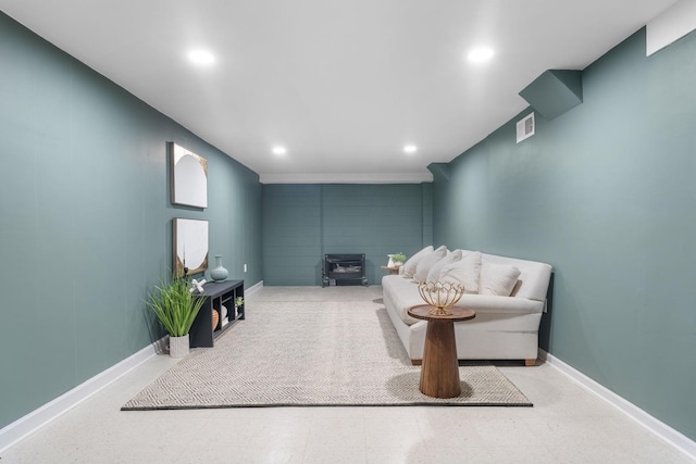 living area with baseboards, visible vents, tile patterned floors, a wood stove, and recessed lighting