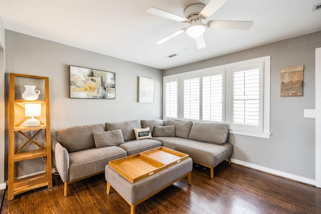 living room featuring baseboards, visible vents, ceiling fan, and dark wood-style flooring