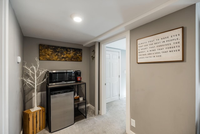 corridor featuring carpet and baseboards