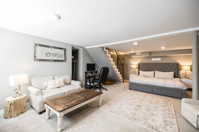 carpeted living area with stairway and visible vents